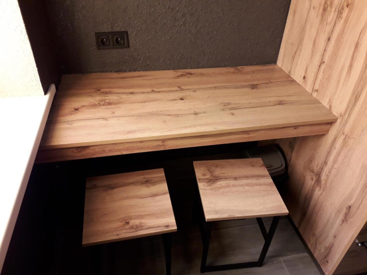 Full House Capsule Hostel Rivne Kültér fotó A table made of wood