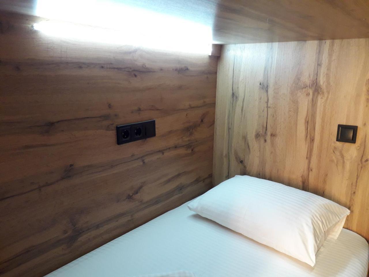 Full House Capsule Hostel Rivne Kültér fotó A single bed in a capsule hotel